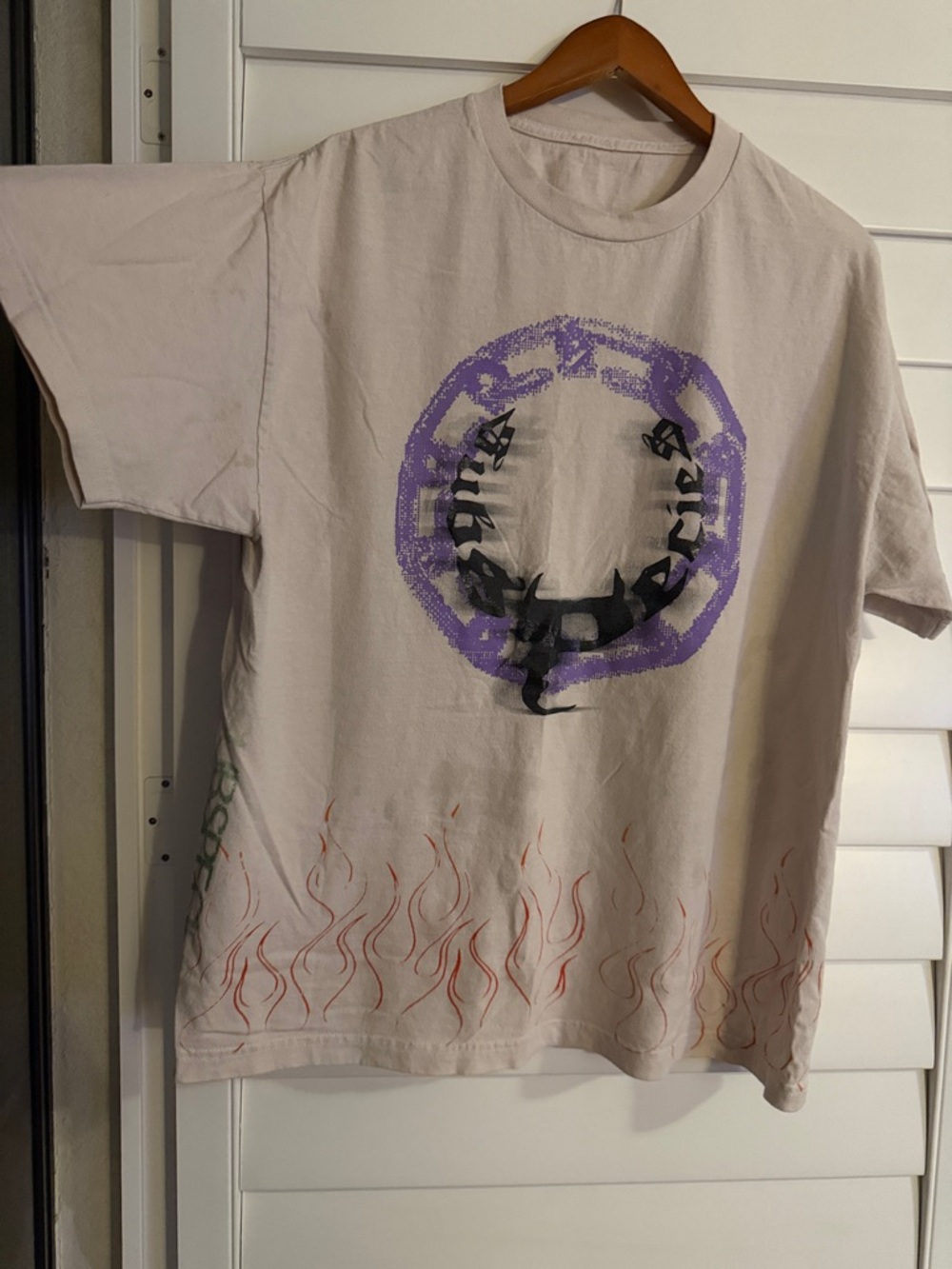 Beige Graphic Tee with Purple Emblem and Red Flame Print
